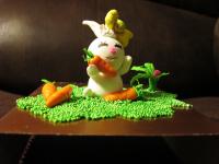 A rabbit is delighted to find so many carrots in the grass